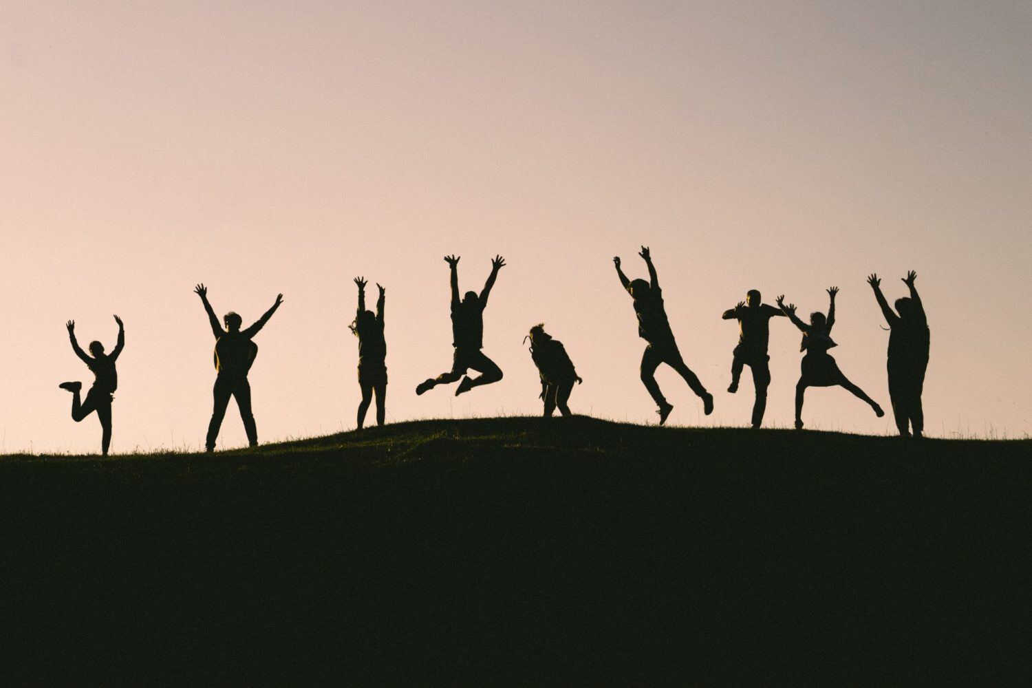 Young people jumping in the air to celebrate ISL diploma results