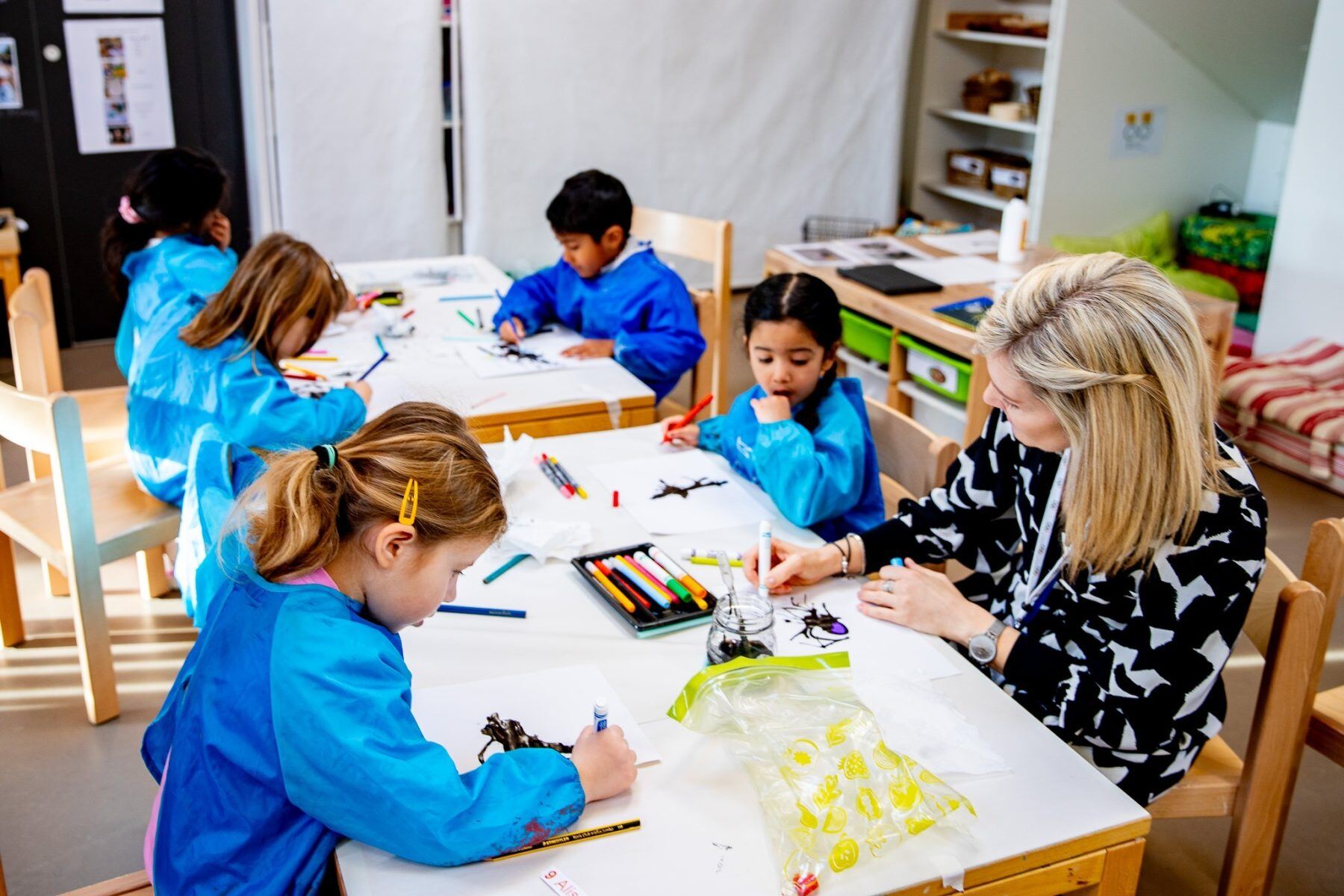 Young ISL Students drawing with their teacher