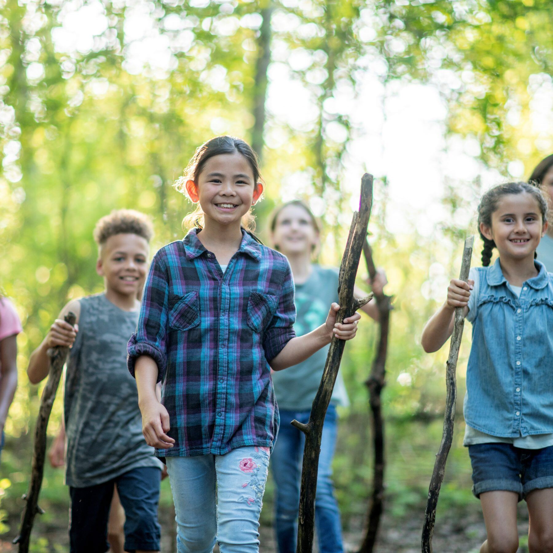 ISL's young students walking in the forest smiling
